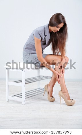 Girl with sore foot isolated on white