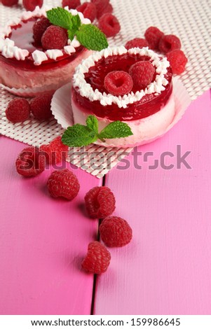 Delicious berry cakes on table close-up