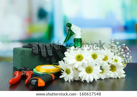 Composition with florist tools on table on bright background