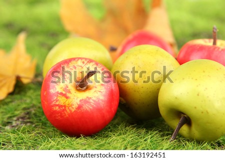 Small apples on nature background