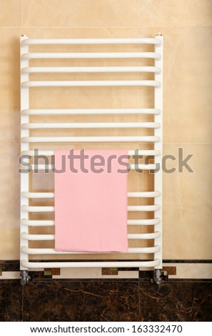 Color towel on  radiator in bathroom
