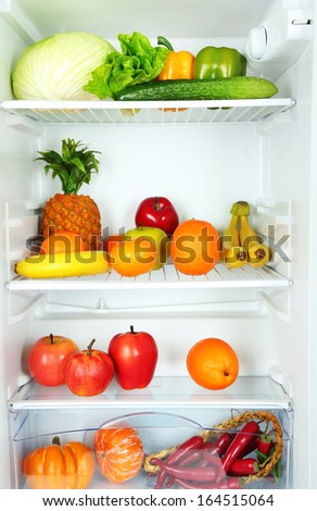 Vegetables and fruits in open refrigerator. Weight loss diet concept.