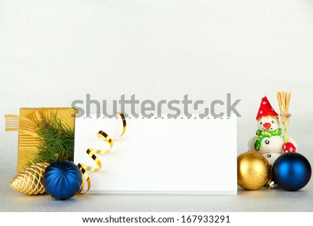 Empty calendar, New Year decor and fir tree on light background
