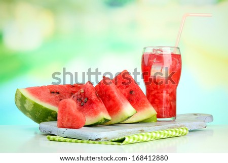 Fresh watermelon and glass of watermelon juice, outdoors