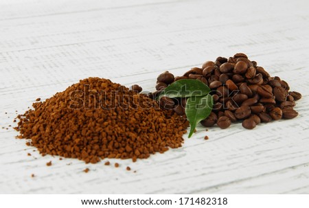 Ground and instant coffee on wooden background