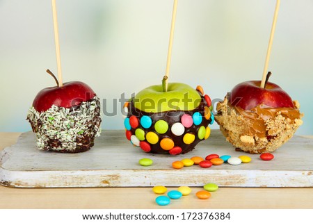Candied apples on sticks on bright background