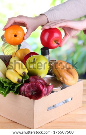 People make out products of box on natural background
