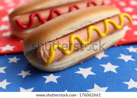 Tasty hot dogs on napkin with stars