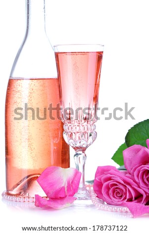 Composition with pink sparkle wine in glass, bottle and pink roses isolated on white