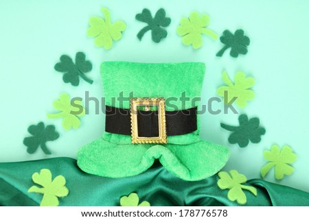 Saint Patrick day hat with clover leaves on green background