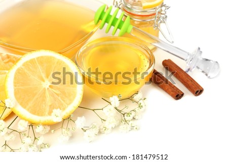 Sweet honey with lemon isolated on white