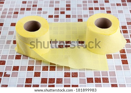 Color toilet paper rolls on bright background