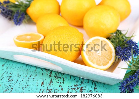Still life with fresh lemons and lavender on wooden table