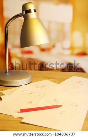 Composition with exam paper, pencil and lamp on table on bright background
