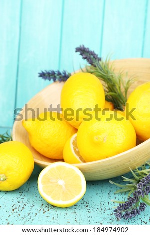 Still life with fresh lemons and lavender on blue background