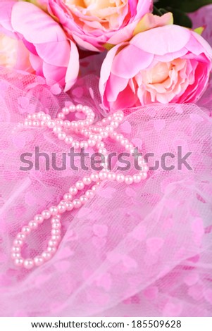 Beautiful pearls on pink cloth