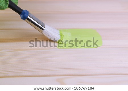 Brush painting wooden furniture, close up