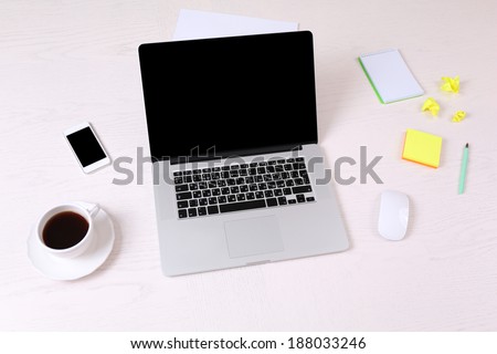 Office workplace with open laptop on wooden desk