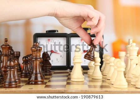 Woman playing chess, close up