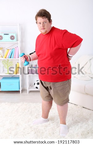 Large fitness man working out  at home