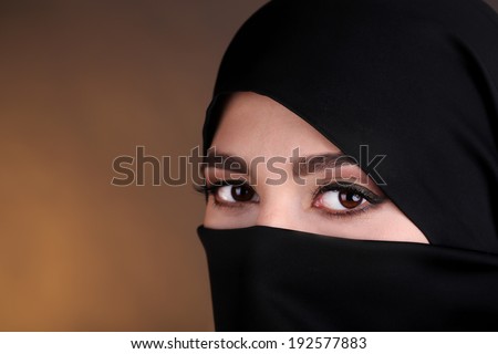 Beautiful muslim arabic woman in paranja on dark color background