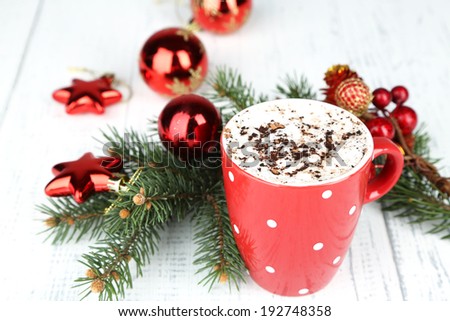 Hot chocolate with cream in color mug, on table, on Christmas decorations background