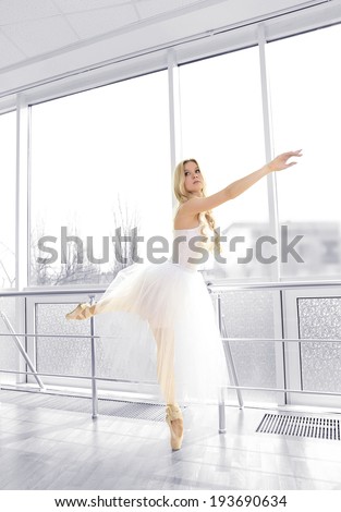 Beautiful balerina practicing in ballet class