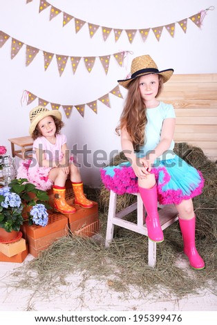 Beautiful small girls in petty skirts on country style background