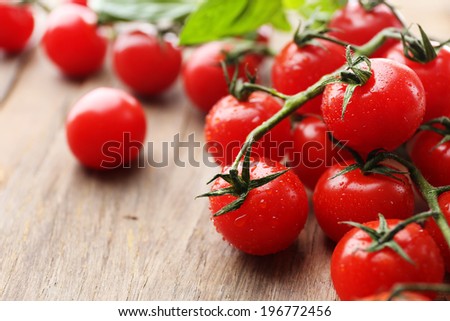 Fresh cherry tomatoes on old wooden table