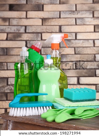 Cleaning products on shelf on bricks wall background