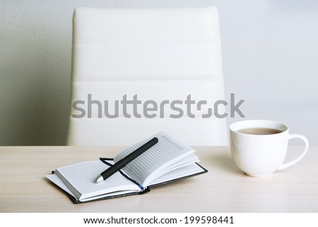 Empty workplace in office on gray background