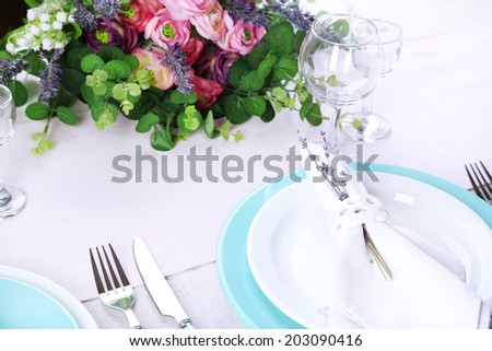 Dining table setting with lavender flowers on table, close-up. Lavender wedding concept