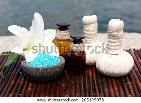 Herbal remedies for massage on bamboo mat, outdoor