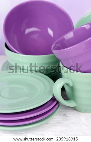 Bright dishes on table on bright background