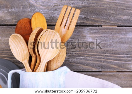 Composition of wooden cutlery, on wooden background