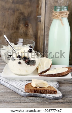 Dairy products: milk, butter, cottage cheese on wooden background