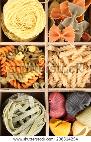 Colorful pasta in wooden box, close-up