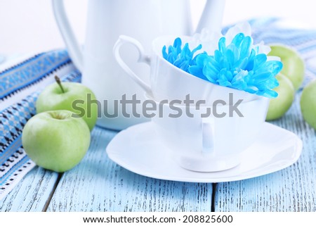 White and blue chrysanthemum with tableware on table close-up