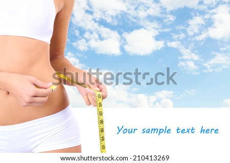Slim girl with tape on sky background