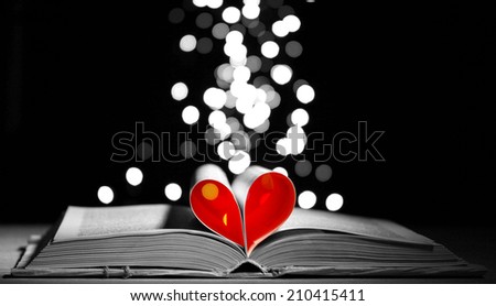 Open book on table on dark background
