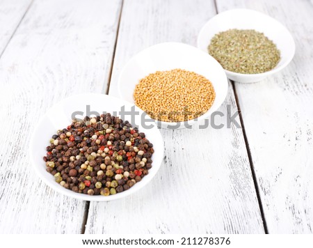 Spice in round bowls on wooden background