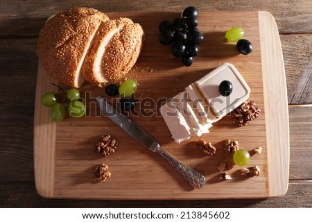 still life with tasty cheese, grape and bread, close up