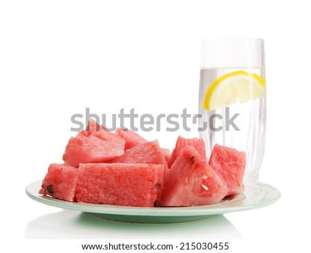 Slices of watermelon on plate with glass of water isolated on white