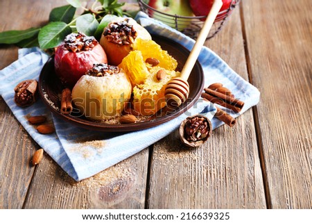 Baked apples on plate on table close up