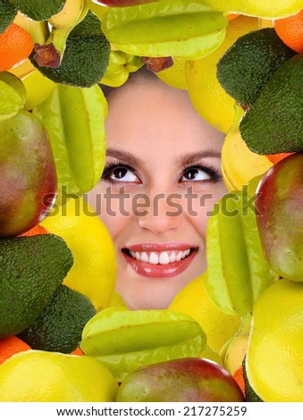 Woman beauty face with fruits frame, close-up