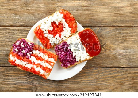 Sandwiches with  different flags on table close-up