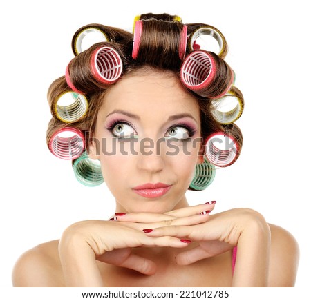 Beautiful girl in hair curlers isolated on white