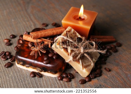 Organic soap with coffee beans and spices, on wooden background. Coffee spa concept