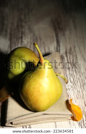 Ripe tasty pears on wooden table