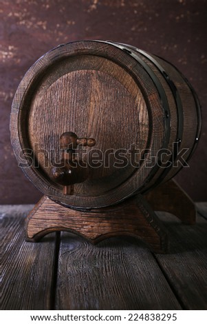 Barrel on wooden table on wooden wall background
